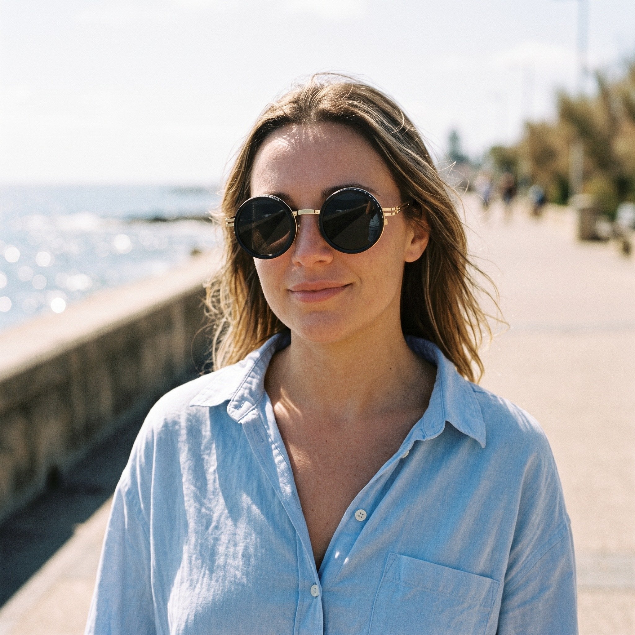 Gold Shadewell sunglasses on a coastal promenade