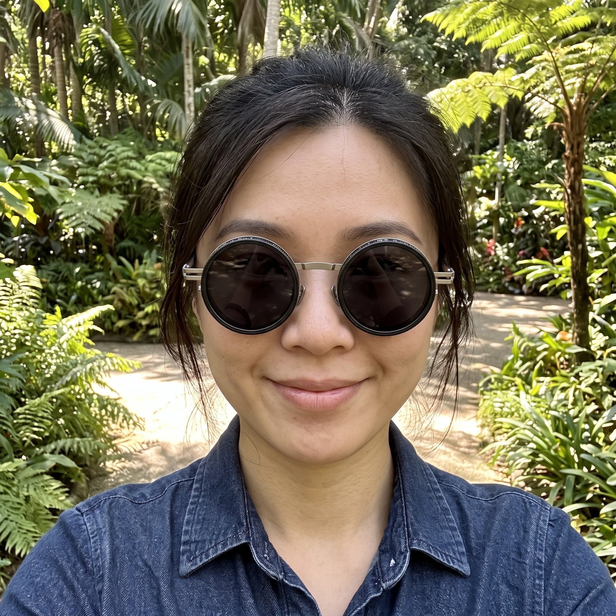 Silver sunglasses worn in a botanical garden