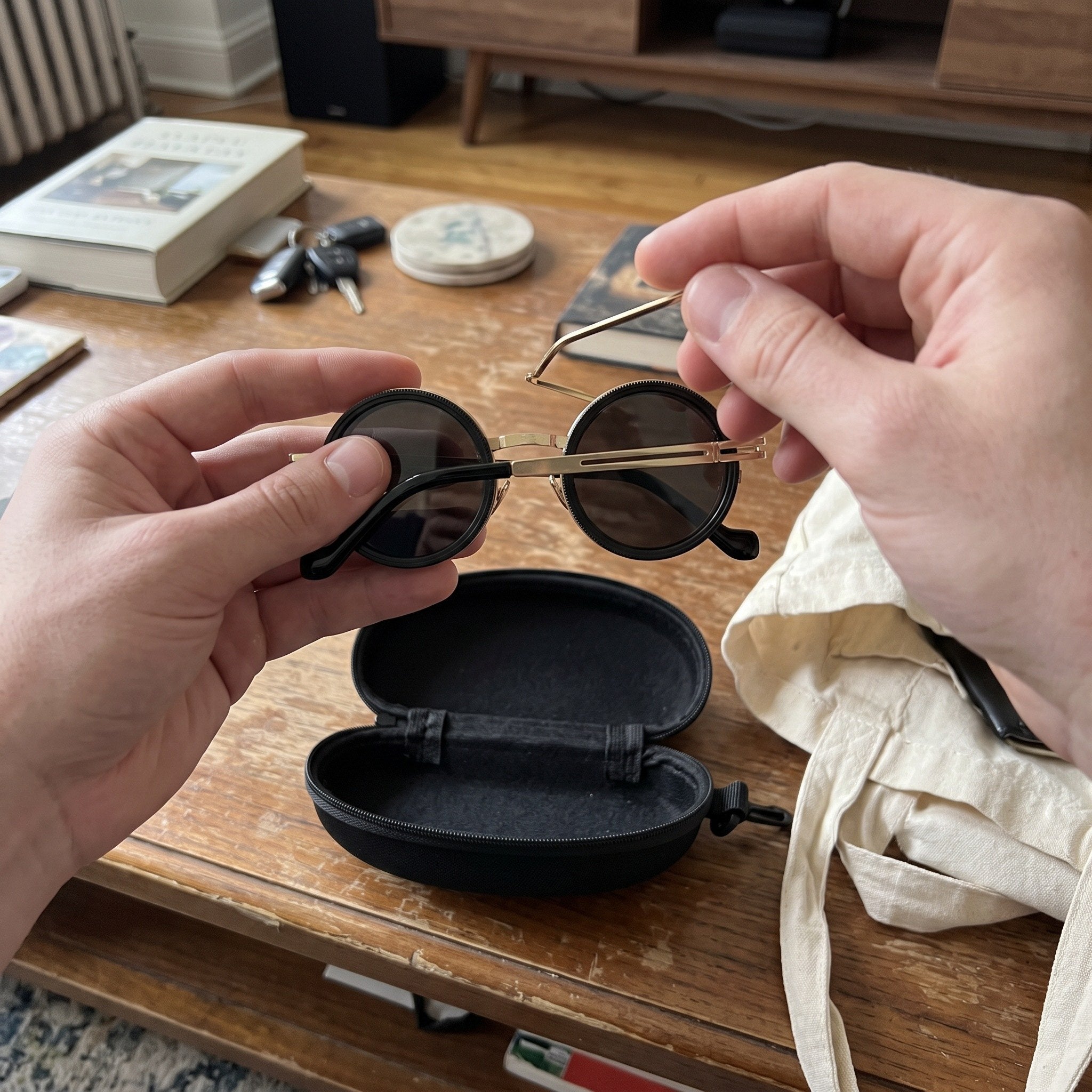 Gold sunglasses folded and packed into their case