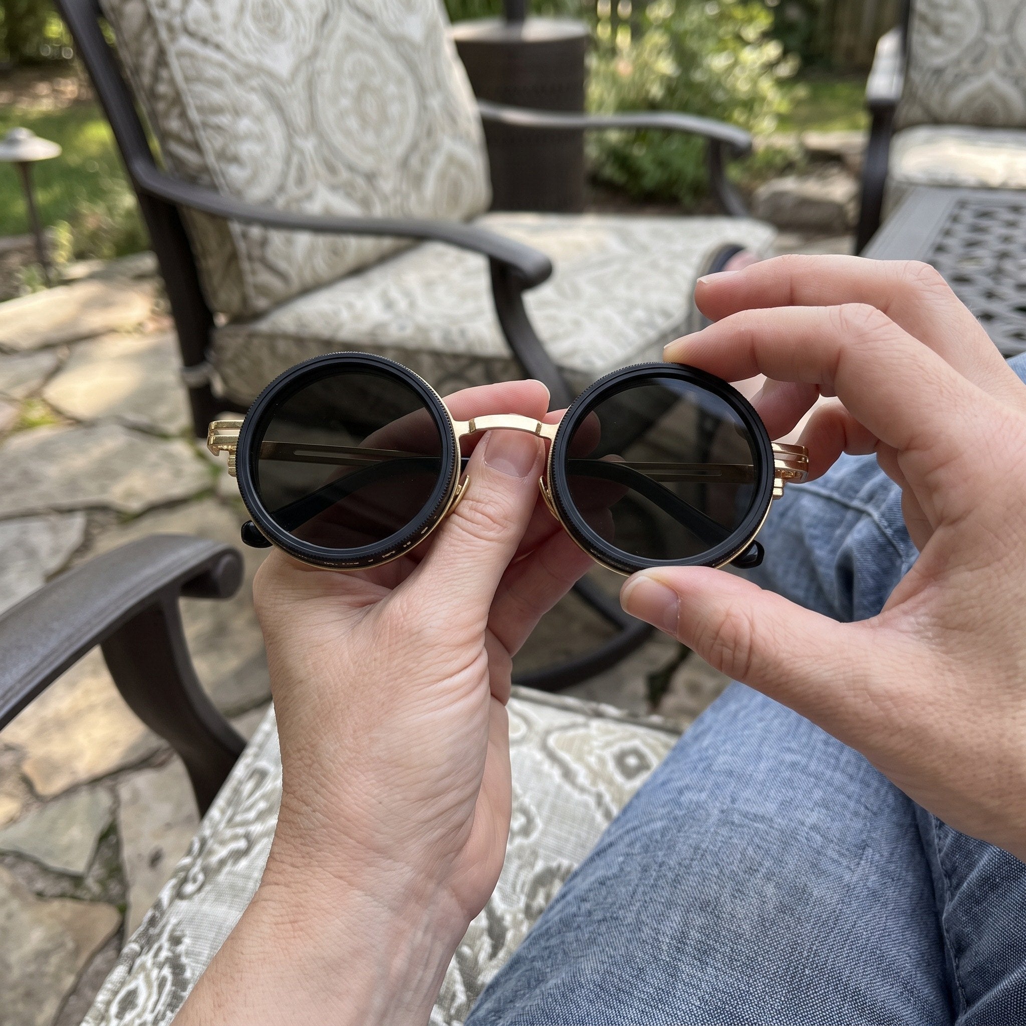 T.W. adjusting Gold Shadewell sunglasses on a patio