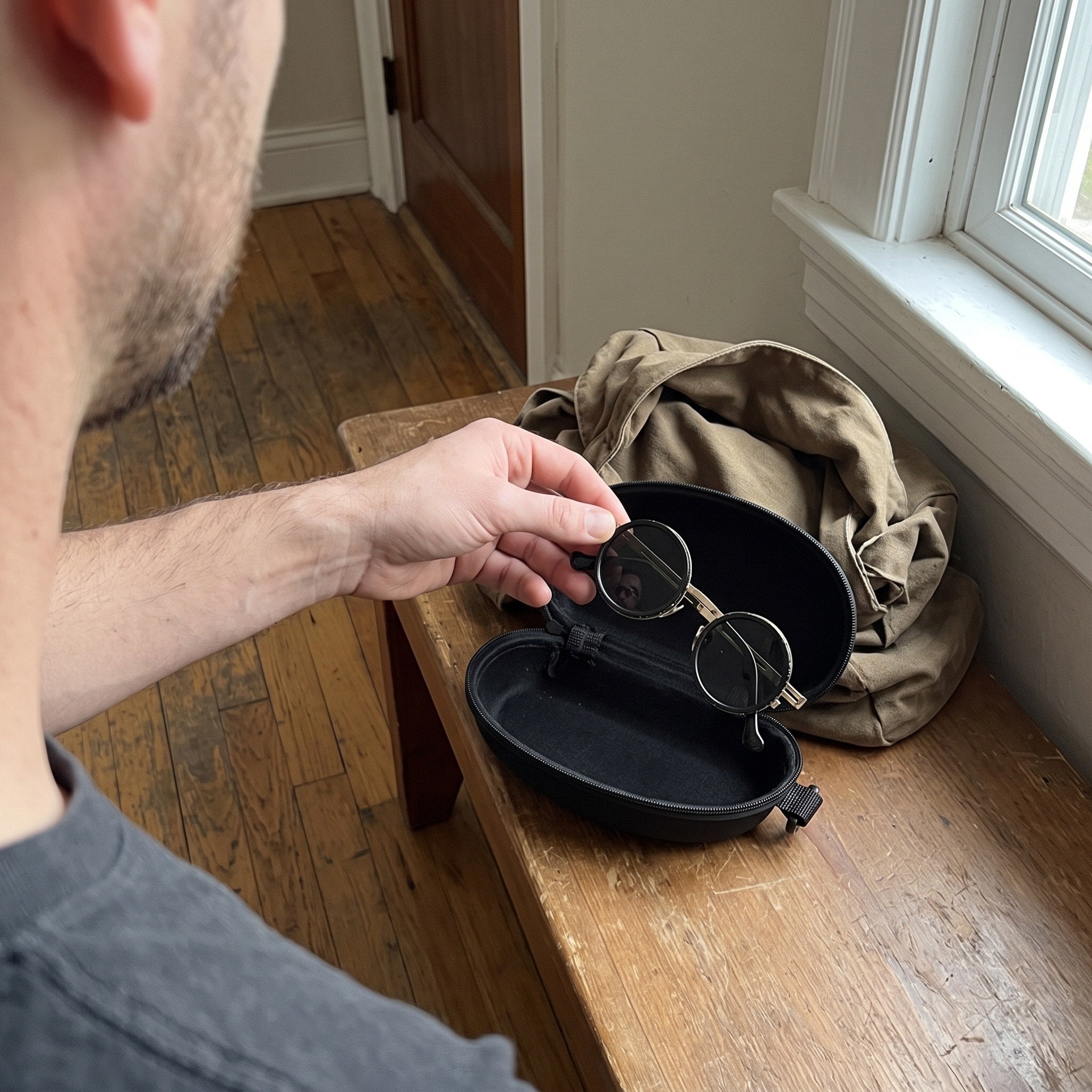 N.T. packing Silver Shadewell sunglasses into the case